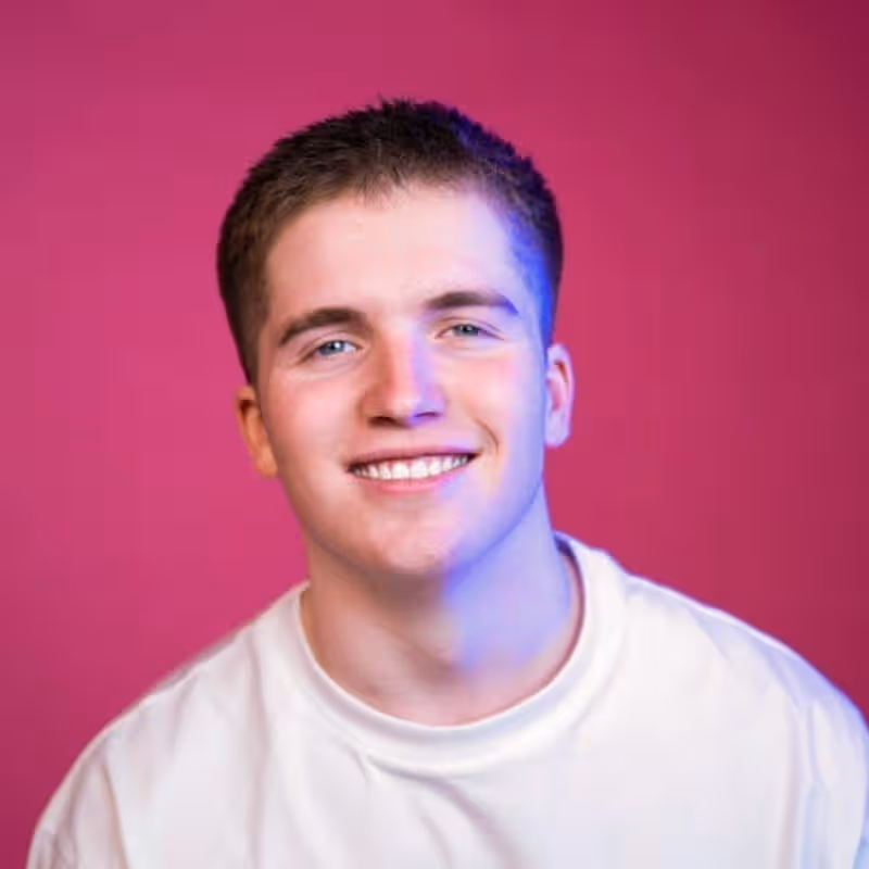 Marketing professional smiling against vibrant magenta background
