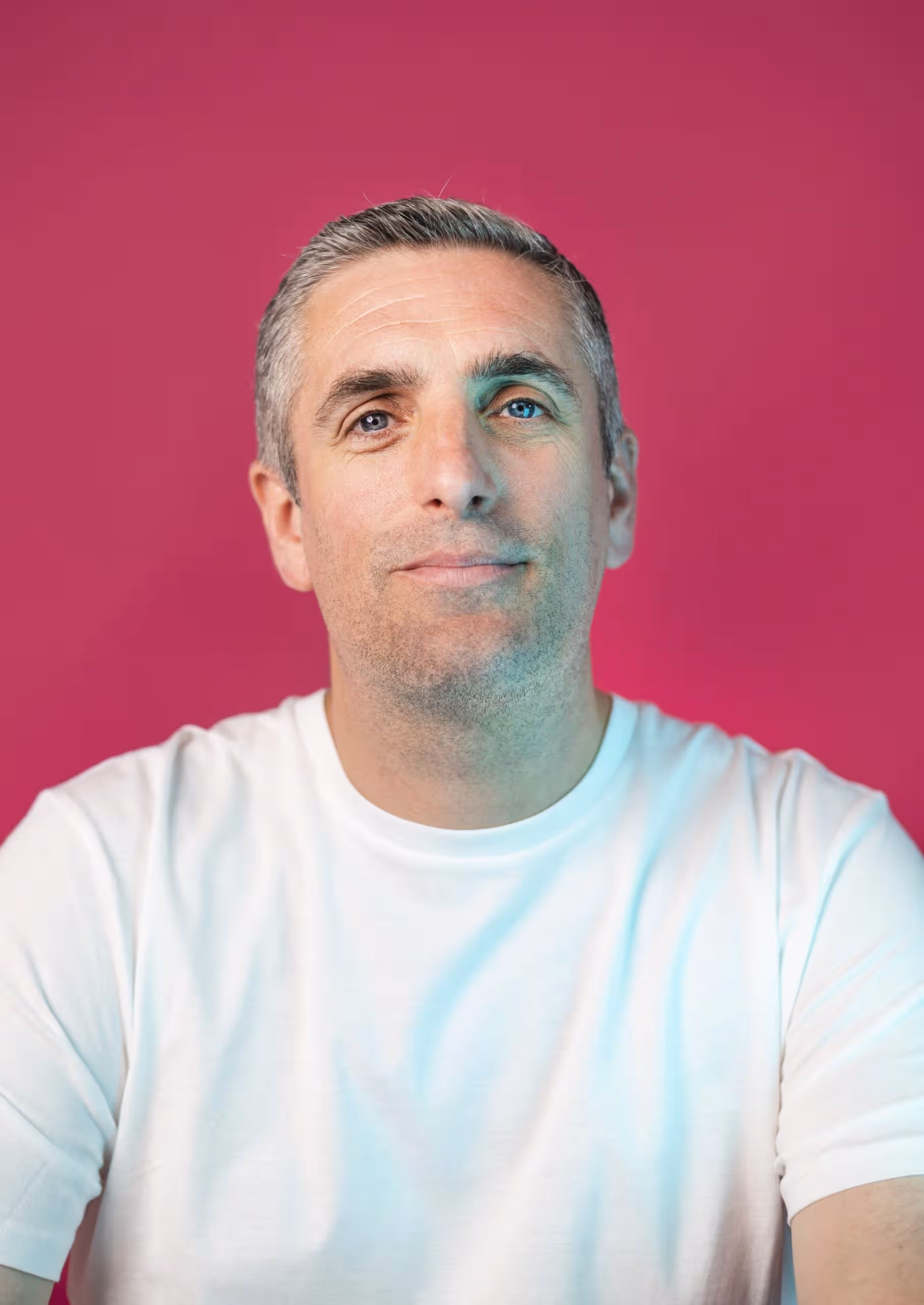 Man in white t-shirt against pink background, Salience marketing page.